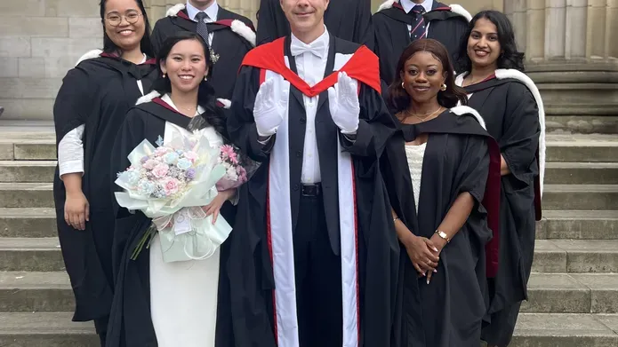 Dean of Dentistry, Professor Philip Preshaw, is presented with the white gloves by some of this year's cohort of graduates.