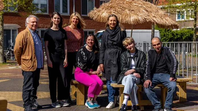 Members of the Urban ReLeaf team stand lined up, smiling