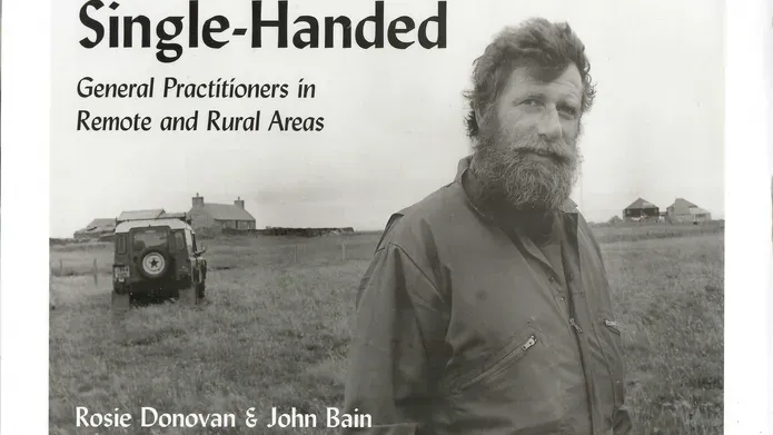 Book cover of the book ‘Single Handed’, a black and white image of a man standing in a field with a land rover behind him.