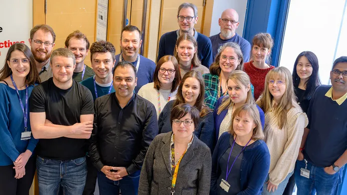 A group of people stood together smiling