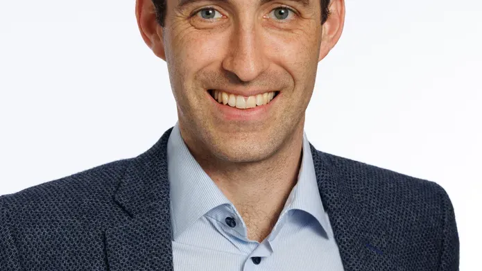 A portrait shot of Dr Mark Baxter infront of a white background