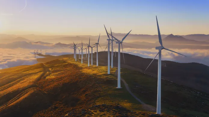 Pictures of a series of wind turbines on a hill at sunrise