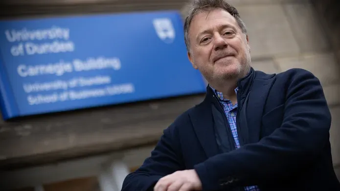 Gordon Craig standing outside the School of Business building