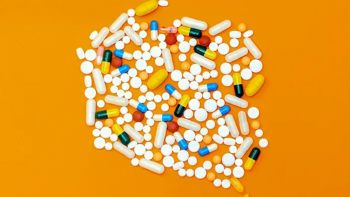 A mixture of medications on an orange background