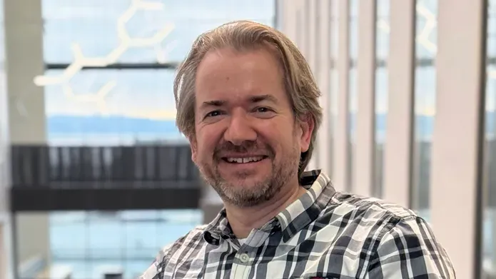 Head and shoulders shot of a man smiling. 