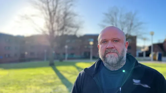 David Lyon, wearing a black fleece in the quadrangle of the School of Health Sciences, Kirkcaldy.