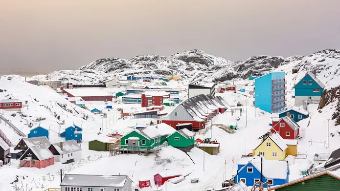 An image of homes on Greenland surrounded by snow