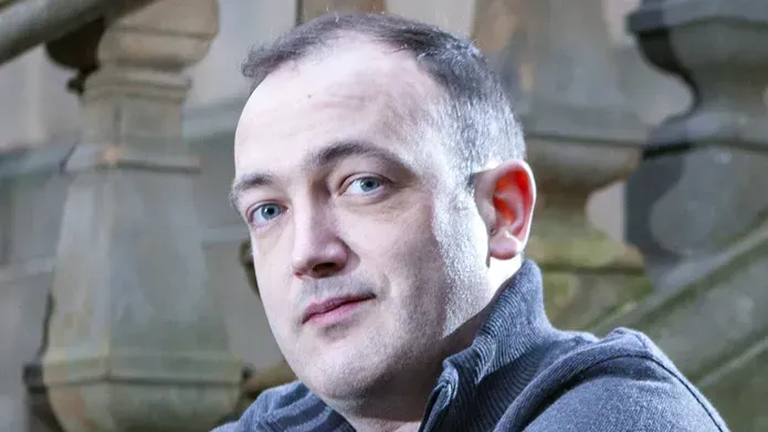 Headshot of Nick Brewer