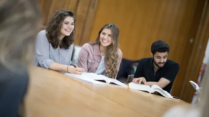 Students sitting together in a class smiling