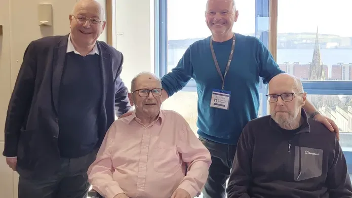 Four people, two stood and two seated.