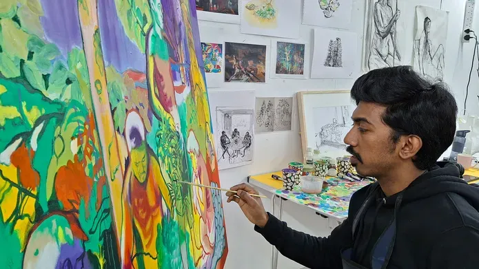Ujwal adding final touches to his painting in a DJCAD studio