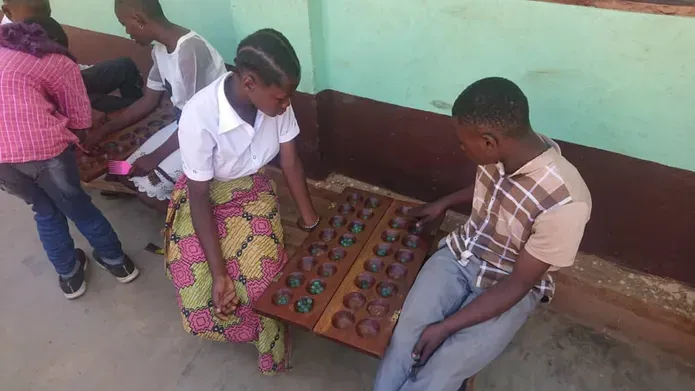 African street children sitting and playing a game