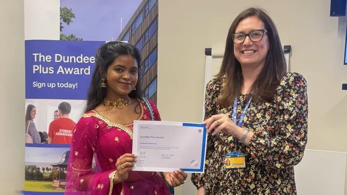 two women holding a certificate
