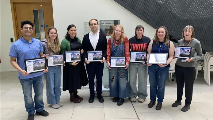 people stood together smiling holding award certificates
