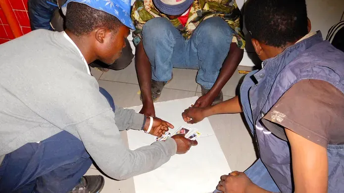 African street children sitting and playing a game