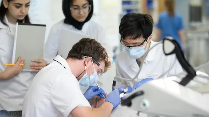 Dentistry students wearing protective masks and glasses performing clinical skills at Dundee.