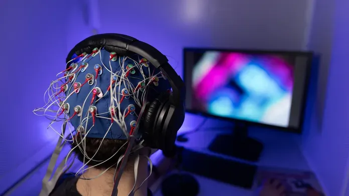 Psychology student sitting with Electroencephalogram EEG headset on