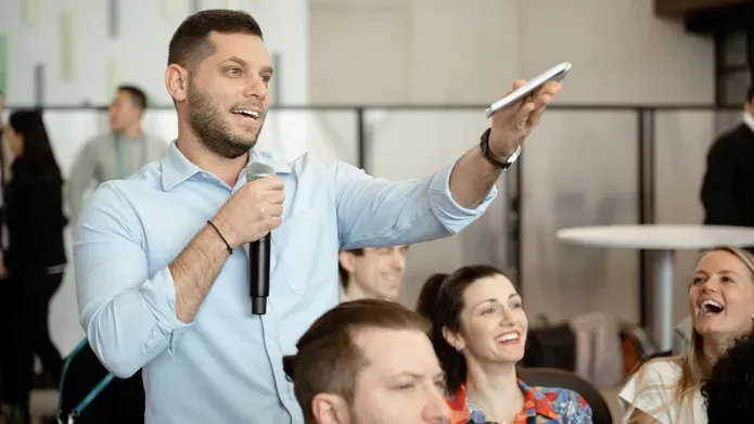 man holding microphone and gesturing