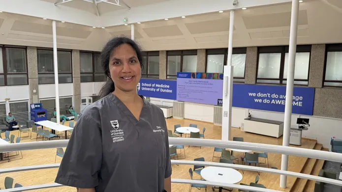 Anna Anandarajah in medical scrubs within the School of Medicine, Ninewells. 