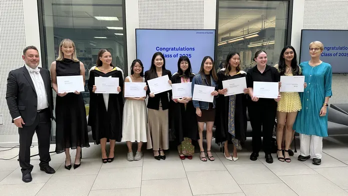 A group of people smiling with their prize certificates