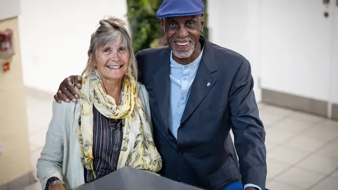 Keith Harris and his wife, Helen, stand on the steps in DUSA where they first met while studying