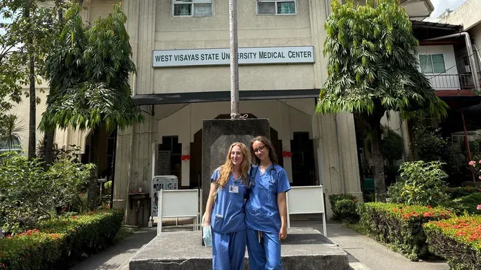 Two medical students stand outside a medical centre in Phillipines