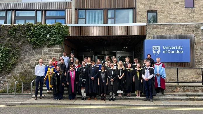 Graduates from HSSL standing in front of Tower Building