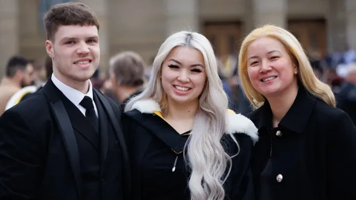 Three graduates outside Caird Hall