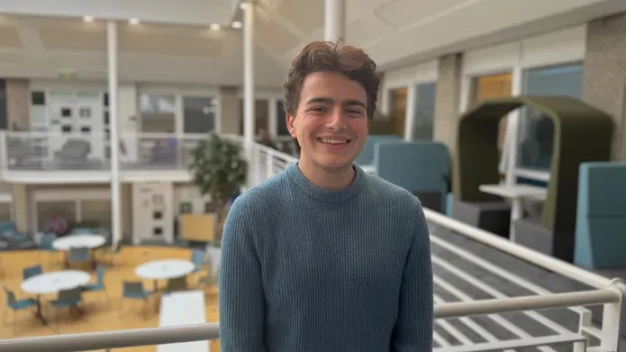 Jack Molenuex in front of railing smiling directly into camera