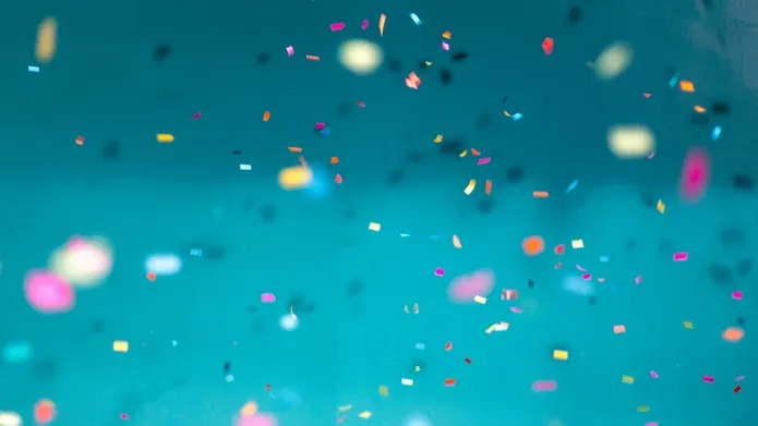confetti in various colours against a light blue background