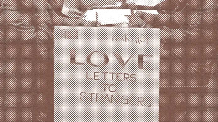 sepia toned photo showing a board with 'Love Letters to Strangers' written on it