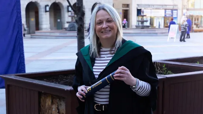 Pam Lawrence recreates her Graduation pose at the most recent University of Dundee Graduation in City Square, Dundee
