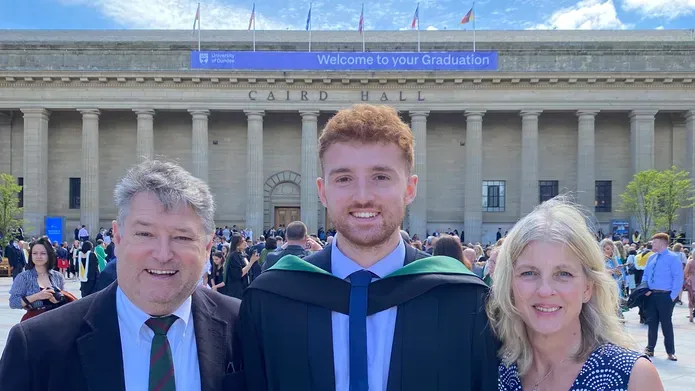 Graduate Euan McClenaghan poses with family on his graduation day in June 2021