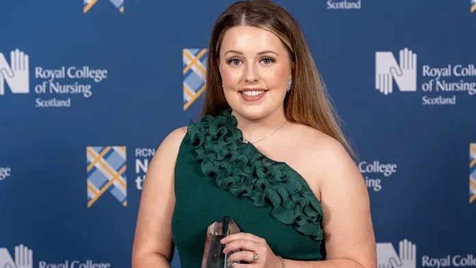 Robyn Oliphant in front of awards background