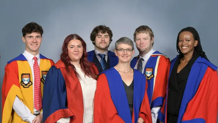Rector Maggie Chapman MSP with DUSA Student Executive, all wearing their academic dress