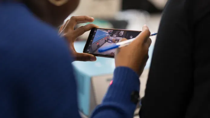 Biomedical Engineering students looking at a phone screen