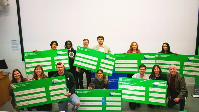 Venture winners holding large cheques