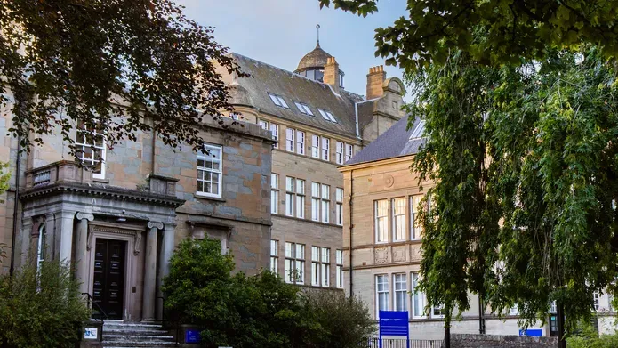 An exterior shot of the School of Business building at dusk