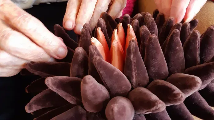 hands feeling a soft sculpture by Karen Scopa