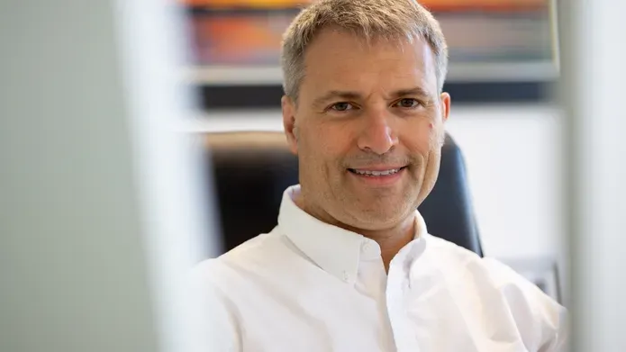 Professor Alessio Ciulii, wearing a white, open-collared shirt.