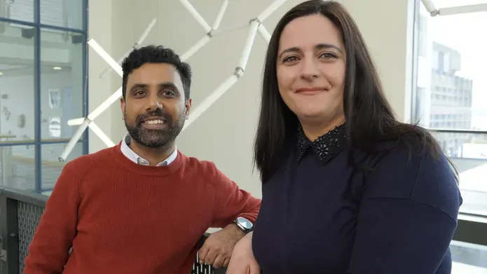 Two people stood next to each other smiling