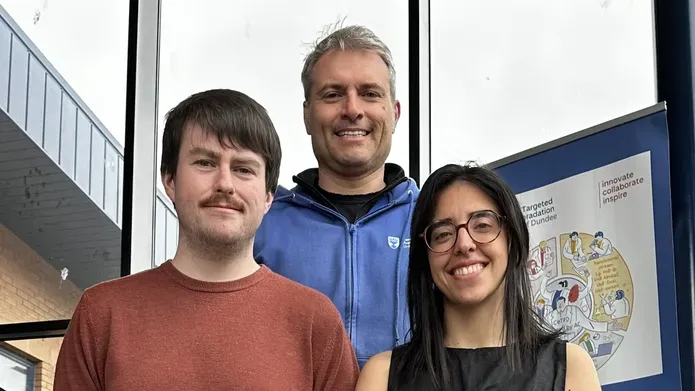 A line-up of researchers Connor Craigon, in orange t-shirt, Professor Alessio Ciulli in a blue sweater, and Maria Rodriguez-Rios, in a black top, and wearing round glasses.