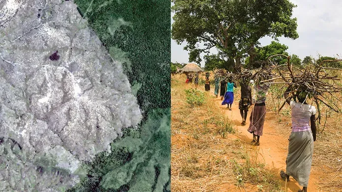 Aerial view of a sandy terrain with some vegetation on the left; women walking with sticks on their heads on the right.