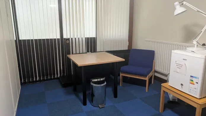 Tower builidng quiet room in the basement has a small table and chair