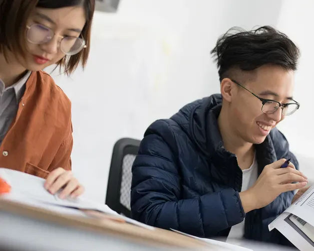 two students studying at a desk