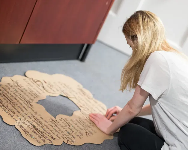 A woman making a cardboard model