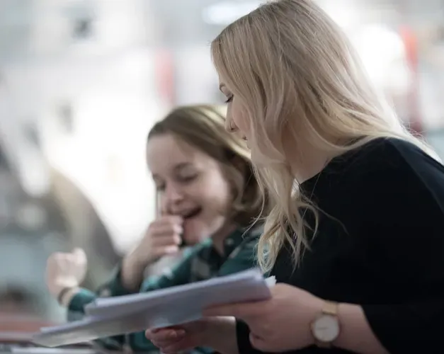 Two students looking at papers