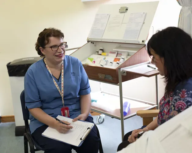Nursing student in classroom with "patient"