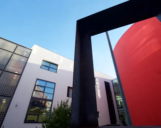 Shot from the ground of the red exterior wall of Dalhousie lecture theatres 1,2, and 3