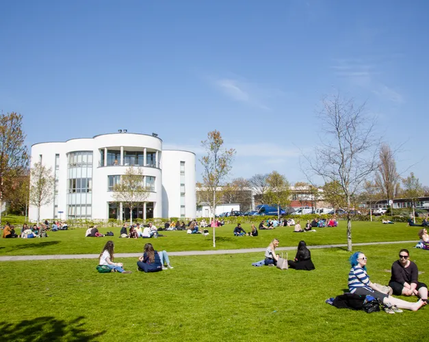 White Queen Mother Building with campus green in front